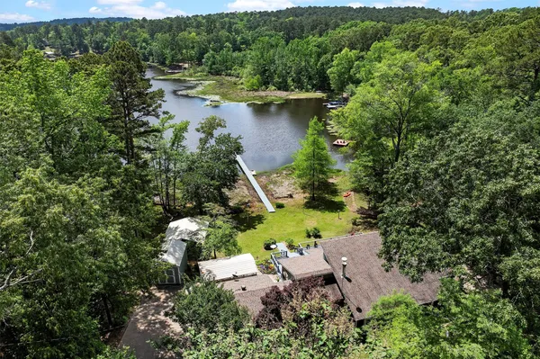 an aerial view of a house with a yard and lake view