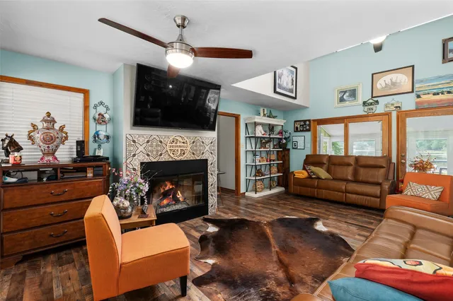 a living room with furniture fireplace and flat screen tv