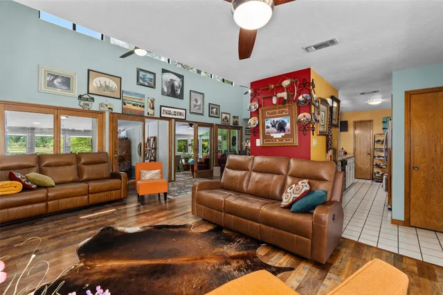 a living room with furniture a couch and paintings on the wall