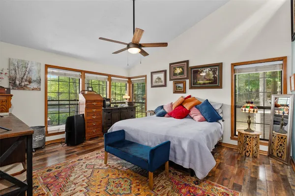a bedroom with a bed and wooden floor