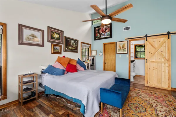 a bedroom with a bed and a table in it