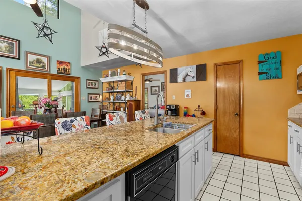 a kitchen with stainless steel appliances granite countertop a sink and cabinets