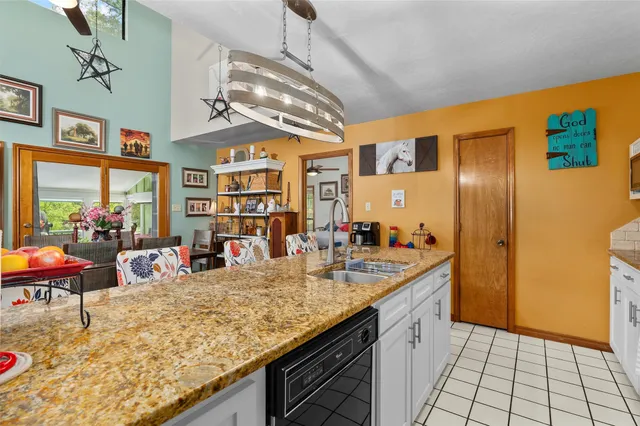 a kitchen with stainless steel appliances granite countertop a sink and cabinets