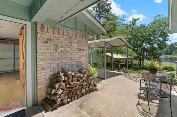 a view of a patio with table and chairs under an umbrella