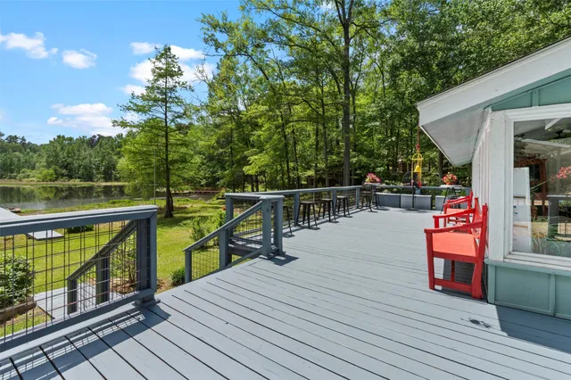a view of deck with chairs and wooden floor