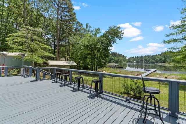 a view of house with deck and outdoor seating
