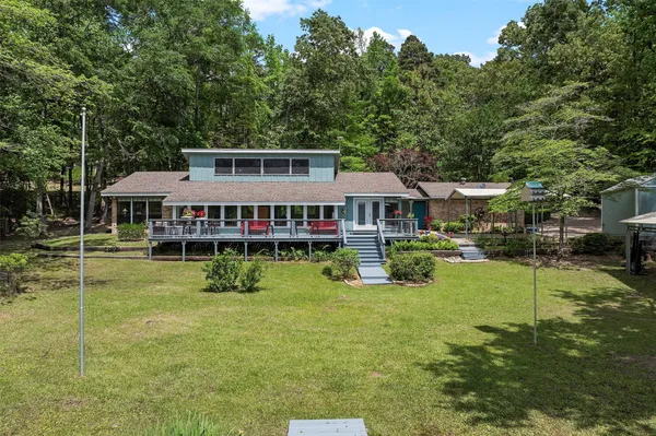 a aerial view of a house with swimming pool next to a big yard
