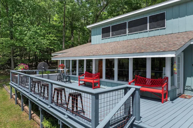 a view of a house with a deck and wooden floor