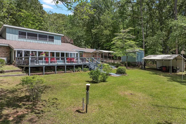 a view of a house with a backyard and a patio