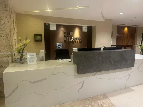 a large white kitchen with a large counter top