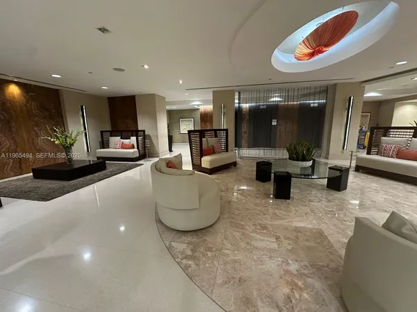 a living room with furniture and kitchen view