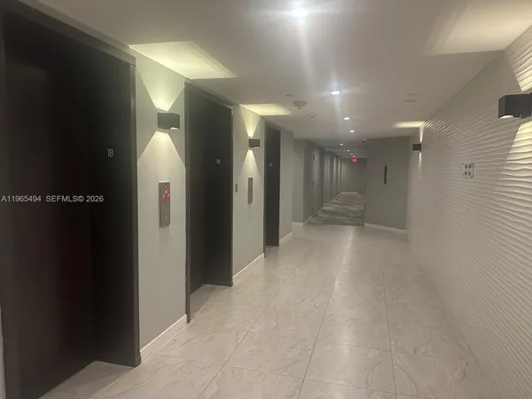 an empty room with closet and windows