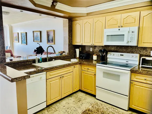 a kitchen with a sink stove and cabinets