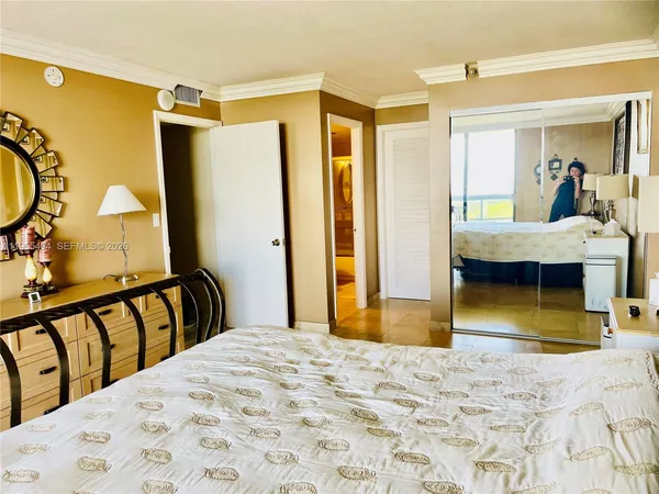 a bedroom with a bed and a mirror