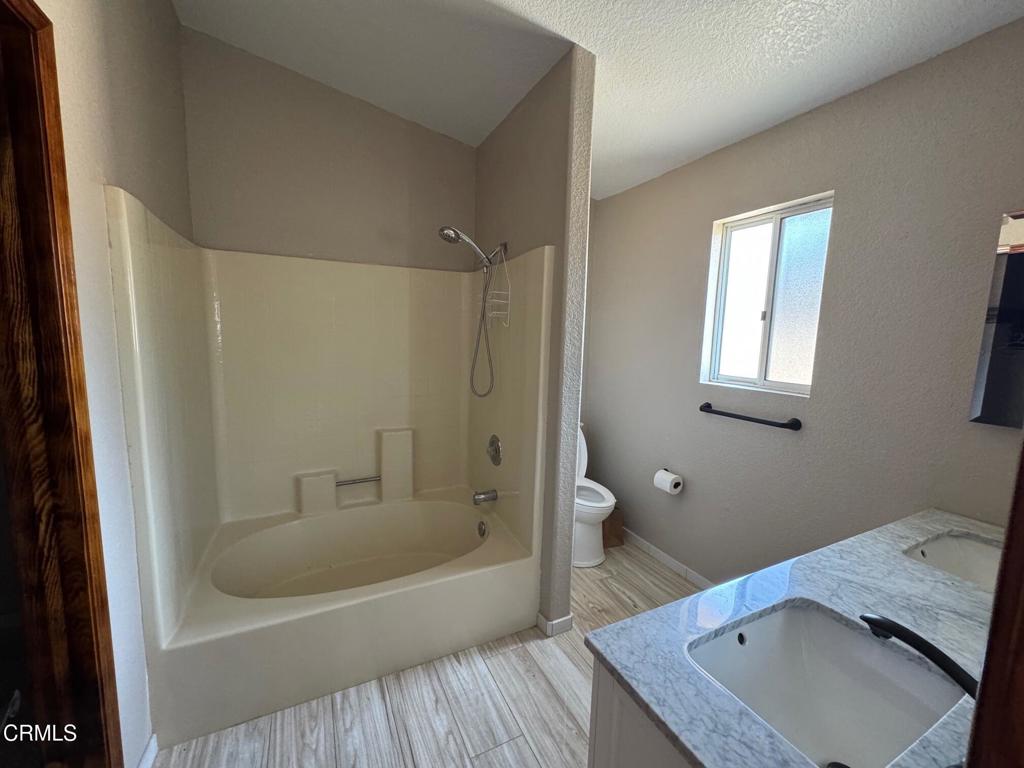 19163 Paradise Mountain Road Valley Center, CA 92082 - Photo 10 of 74 a bathroom with a tub toilet and sink