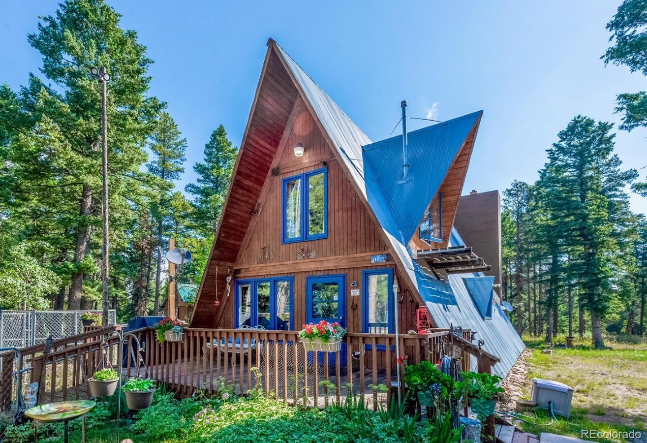 12802 Upper Ridge Road Conifer, CO 80433 - Photo 1 of 27 a view of a house with a small yard and wooden deck
