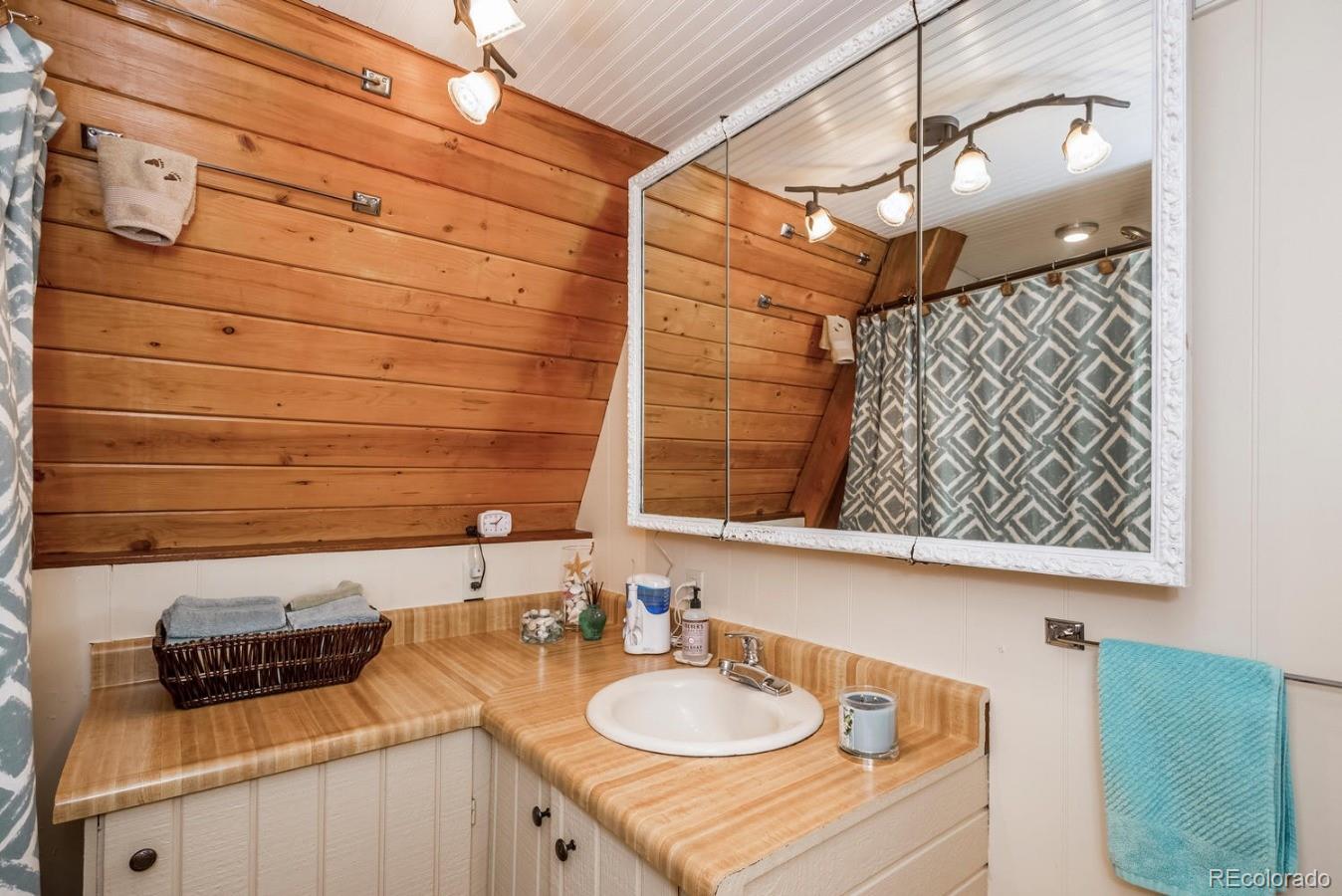 12802 Upper Ridge Road Conifer, CO 80433 - Photo 11 of 27 a bathroom with a sink and a mirror