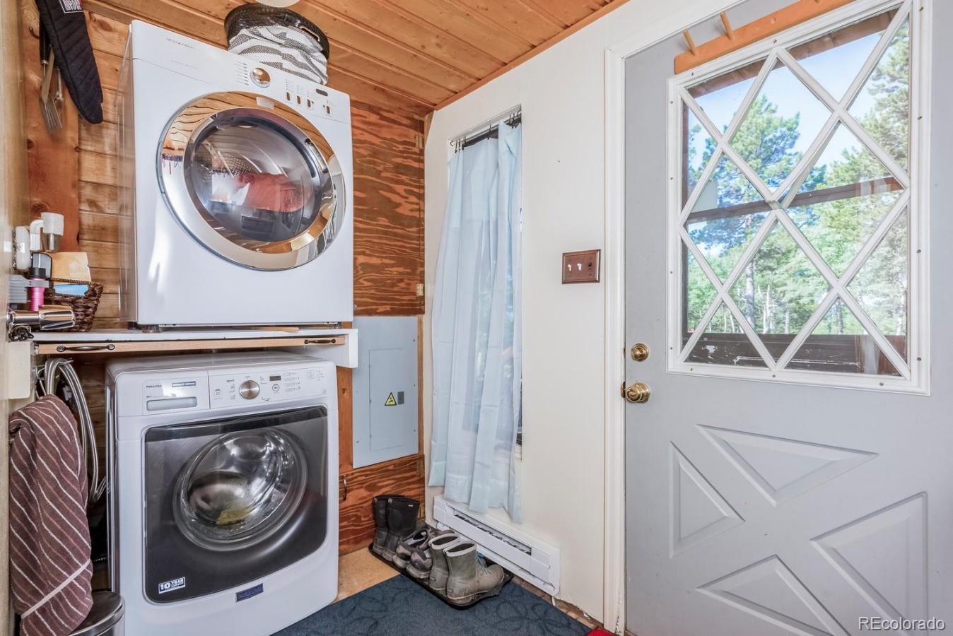 12802 Upper Ridge Road Conifer, CO 80433 - Photo 12 of 27 a utility room with dryer and washer