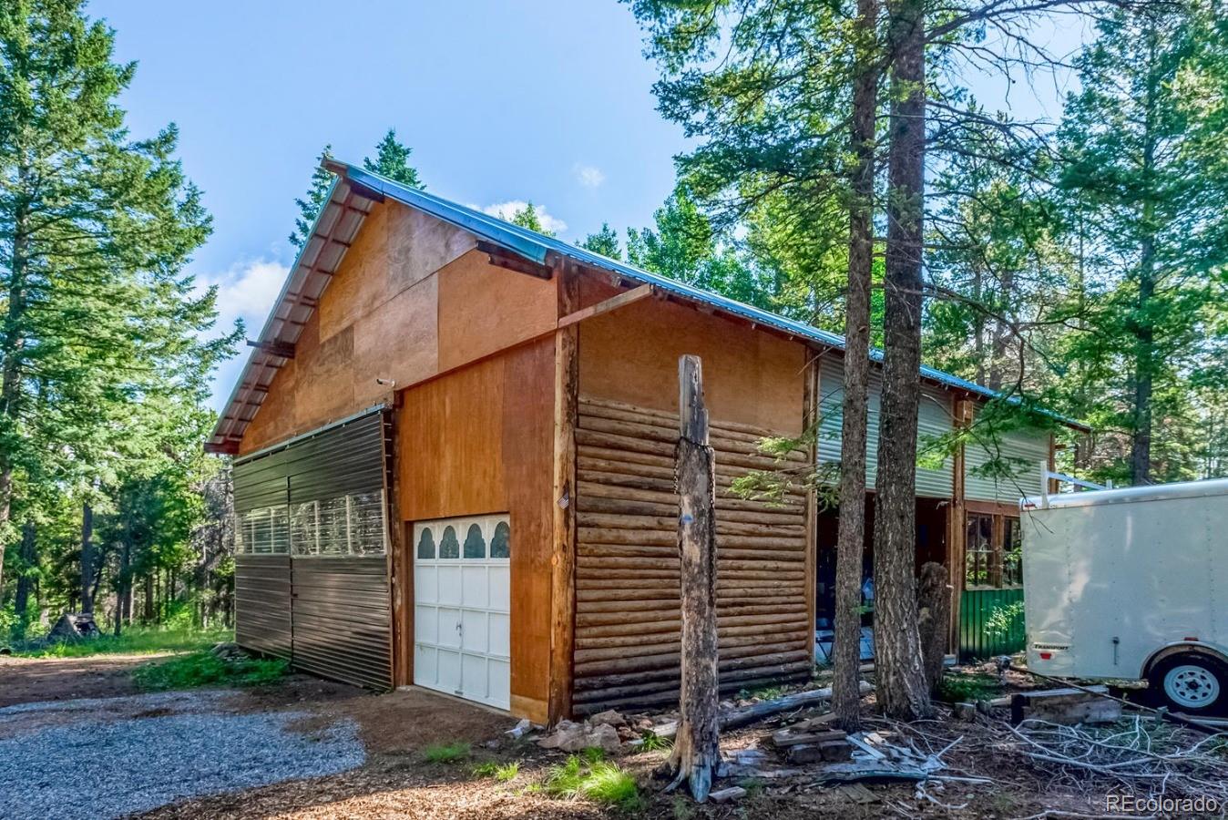 12802 Upper Ridge Road Conifer, CO 80433 - Photo 21 of 27 a view of a house with a yard