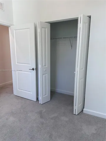 an empty room with closet area