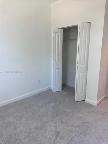 an empty room with closet area