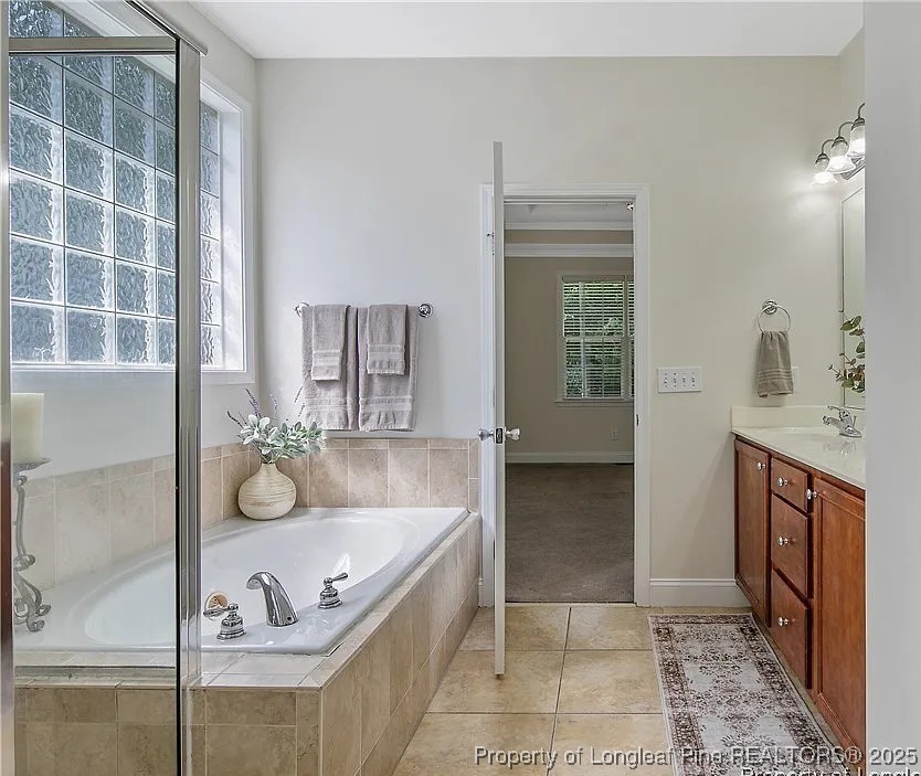 177 Lamplighter Way Spring Lake, NC 28390 - Photo 12 of 21 a bathroom with a tub sink and mirror