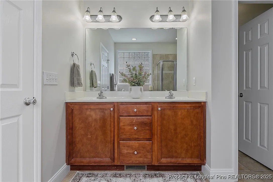 177 Lamplighter Way Spring Lake, NC 28390 - Photo 13 of 21 a bathroom with a granite countertop sink and a mirror