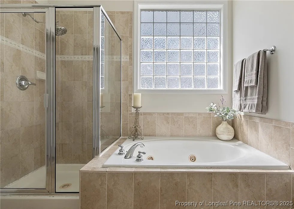 177 Lamplighter Way Spring Lake, NC 28390 - Photo 14 of 21 a bathroom with a tub shower and sink