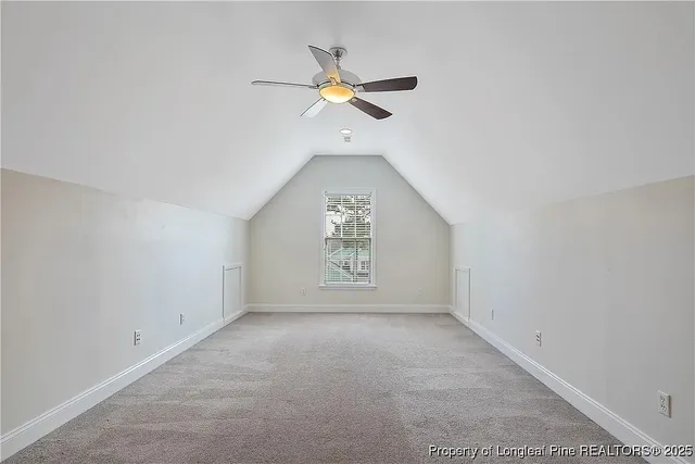 an empty room with a ceiling fan and window