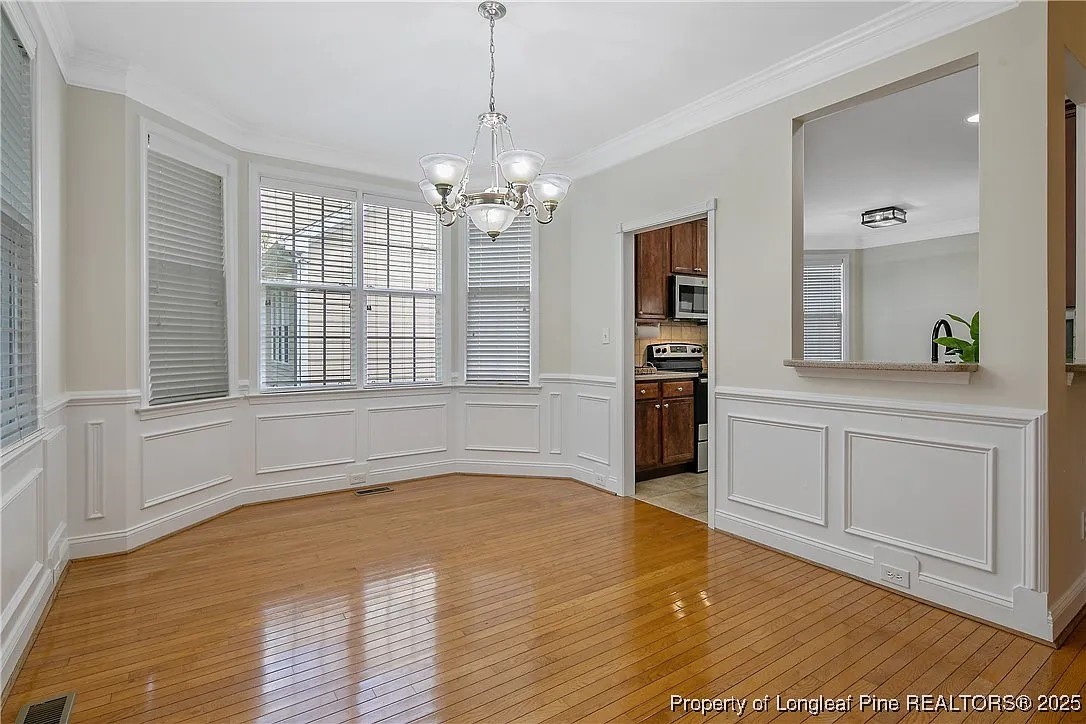 177 Lamplighter Way Spring Lake, NC 28390 - Photo 2 of 21 a view of a kitchen with wooden floor and stainless steel appliances
