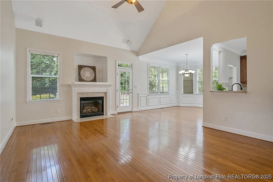 177 Lamplighter Way Spring Lake, NC 28390 - Photo 4 of 21 a view of an empty room with wooden floor and a fireplace