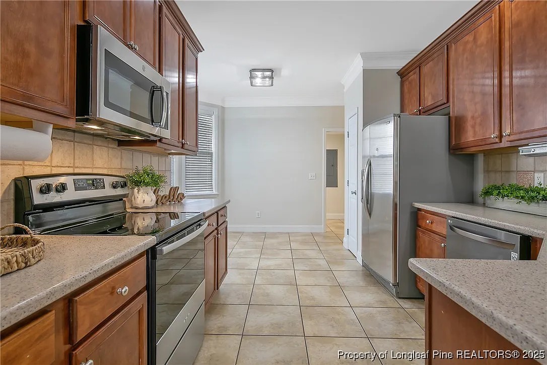 177 Lamplighter Way Spring Lake, NC 28390 - Photo 5 of 21 a kitchen with stainless steel appliances granite countertop a stove a refrigerator and a microwave