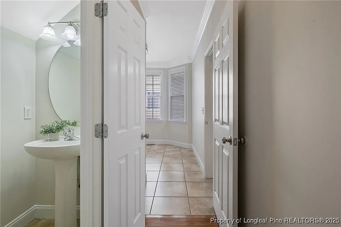 177 Lamplighter Way Spring Lake, NC 28390 - Photo 7 of 21 a bathroom with a sink a mirror and shower