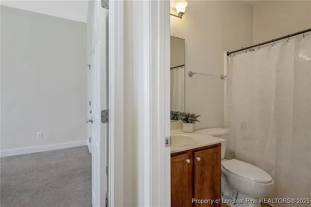 a bathroom with a toilet a sink and a shower