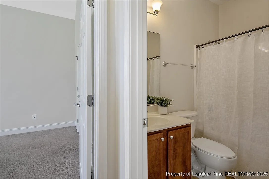 177 Lamplighter Way Spring Lake, NC 28390 - Photo 10 of 21 a bathroom with a toilet a sink and a shower