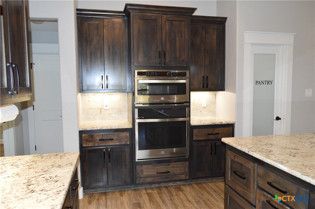 1026 County Road 3152 Kempner, TX 76539 - Photo 9 of 48 The stainless in color appliances include a built-in microwave, built-in oven, dishwasher, glass cooktop, and the freezer-on-the bottom refrigerator is included.