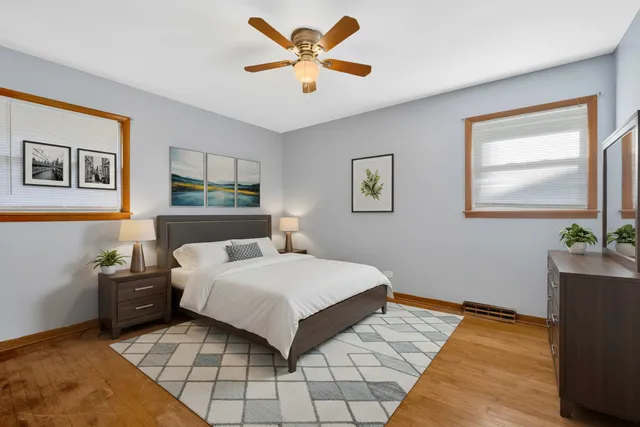 a bedroom with a bed and a painting on the wall