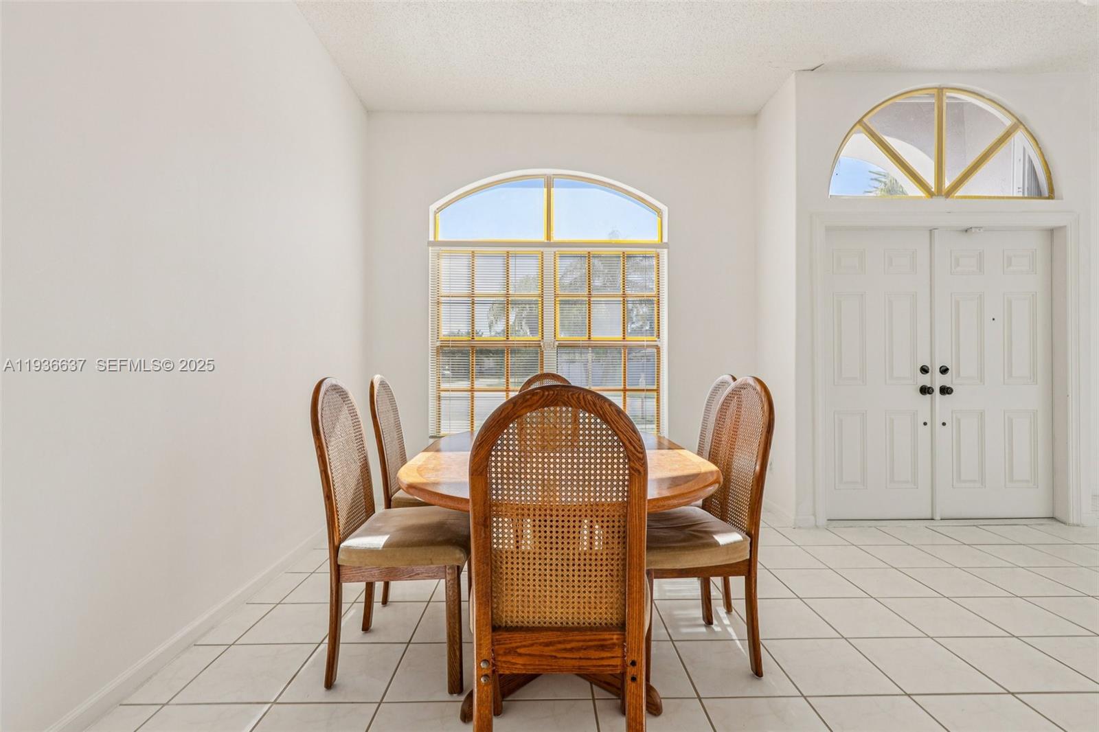 17811 Southwest 4th Court Pembroke Pines, FL 33029 - Photo 13 of 74 a view of a dining room with furniture and a window
