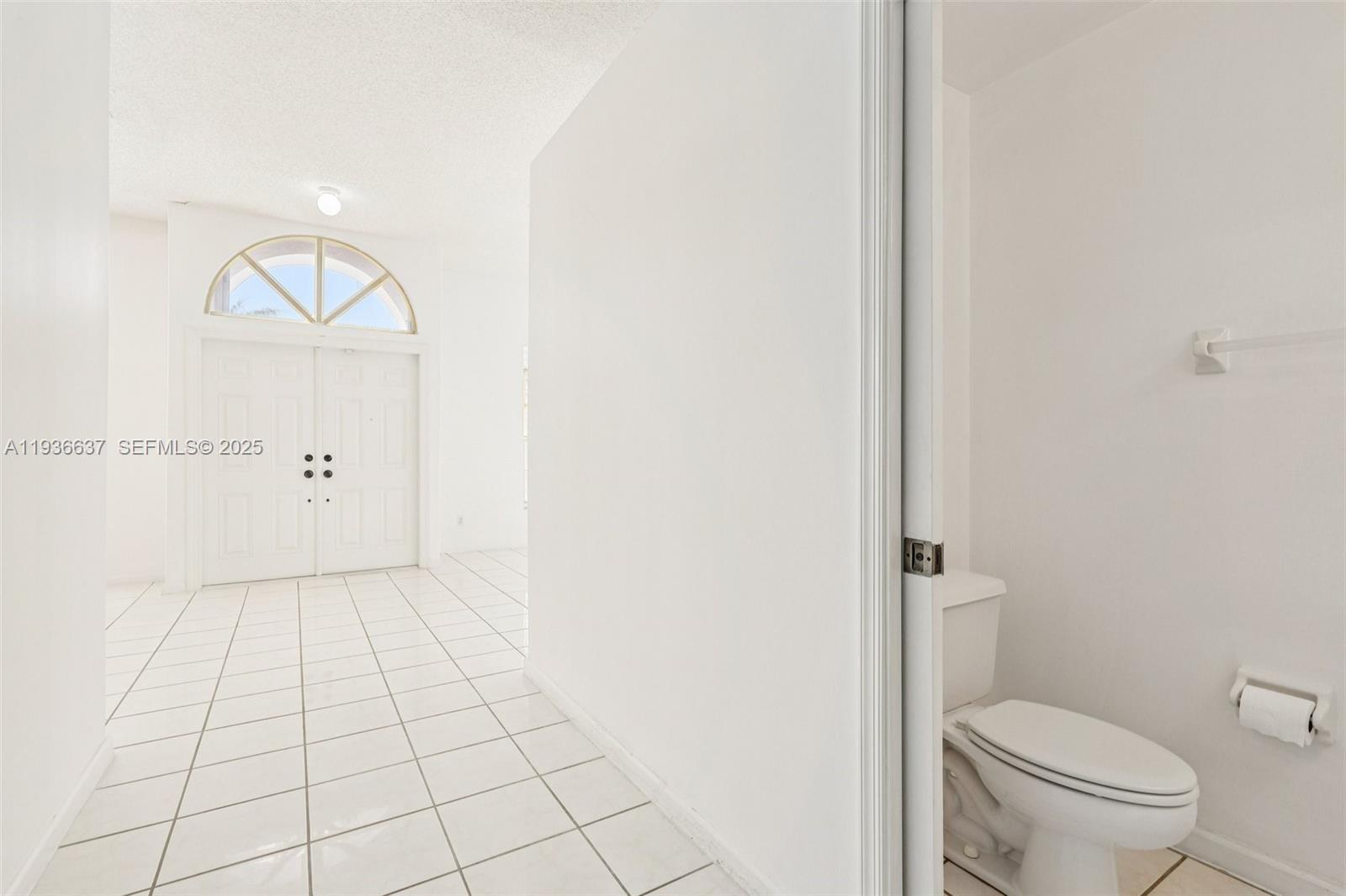 17811 Southwest 4th Court Pembroke Pines, FL 33029 - Photo 14 of 74 a bathroom with a toilet a sink a mirror and vanity