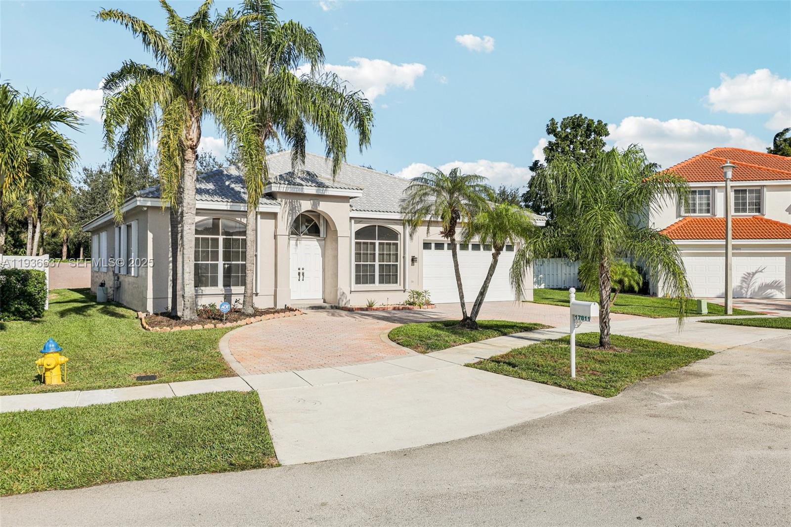 17811 Southwest 4th Court Pembroke Pines, FL 33029 - Photo 2 of 74 a front view of a house with a yard and garage