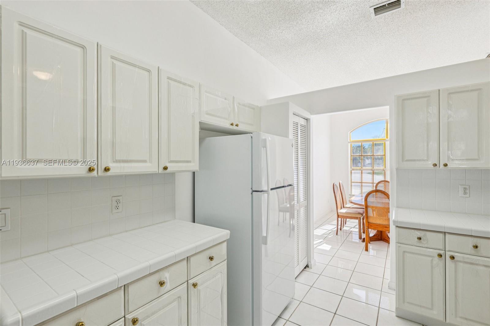 17811 Southwest 4th Court Pembroke Pines, FL 33029 - Photo 22 of 74 a view of kitchen with white cabinets and refrigerator