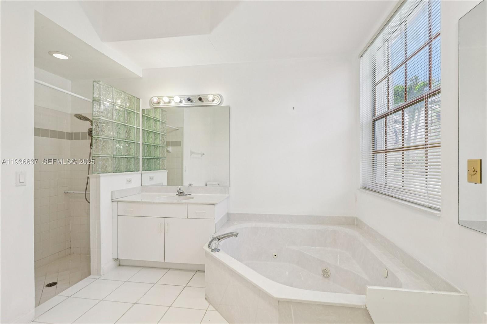 17811 Southwest 4th Court Pembroke Pines, FL 33029 - Photo 37 of 74 a bathroom with a bathtub sink and window
