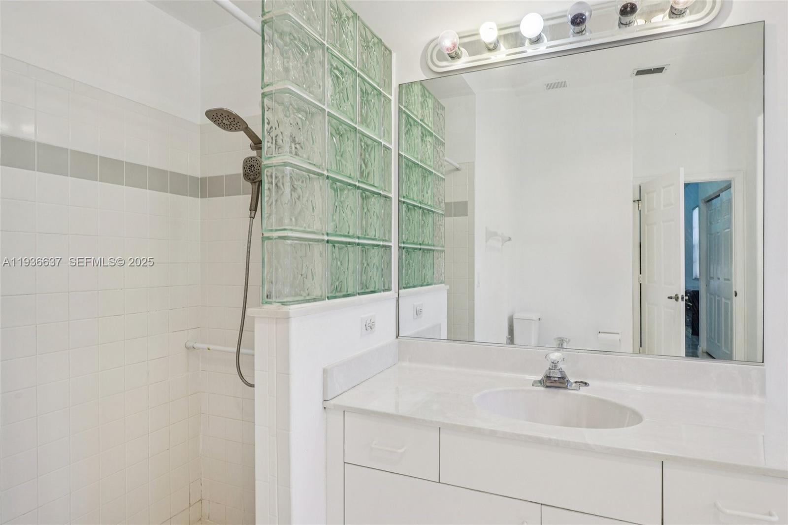 17811 Southwest 4th Court Pembroke Pines, FL 33029 - Photo 39 of 74 a bathroom with a sink and a mirror