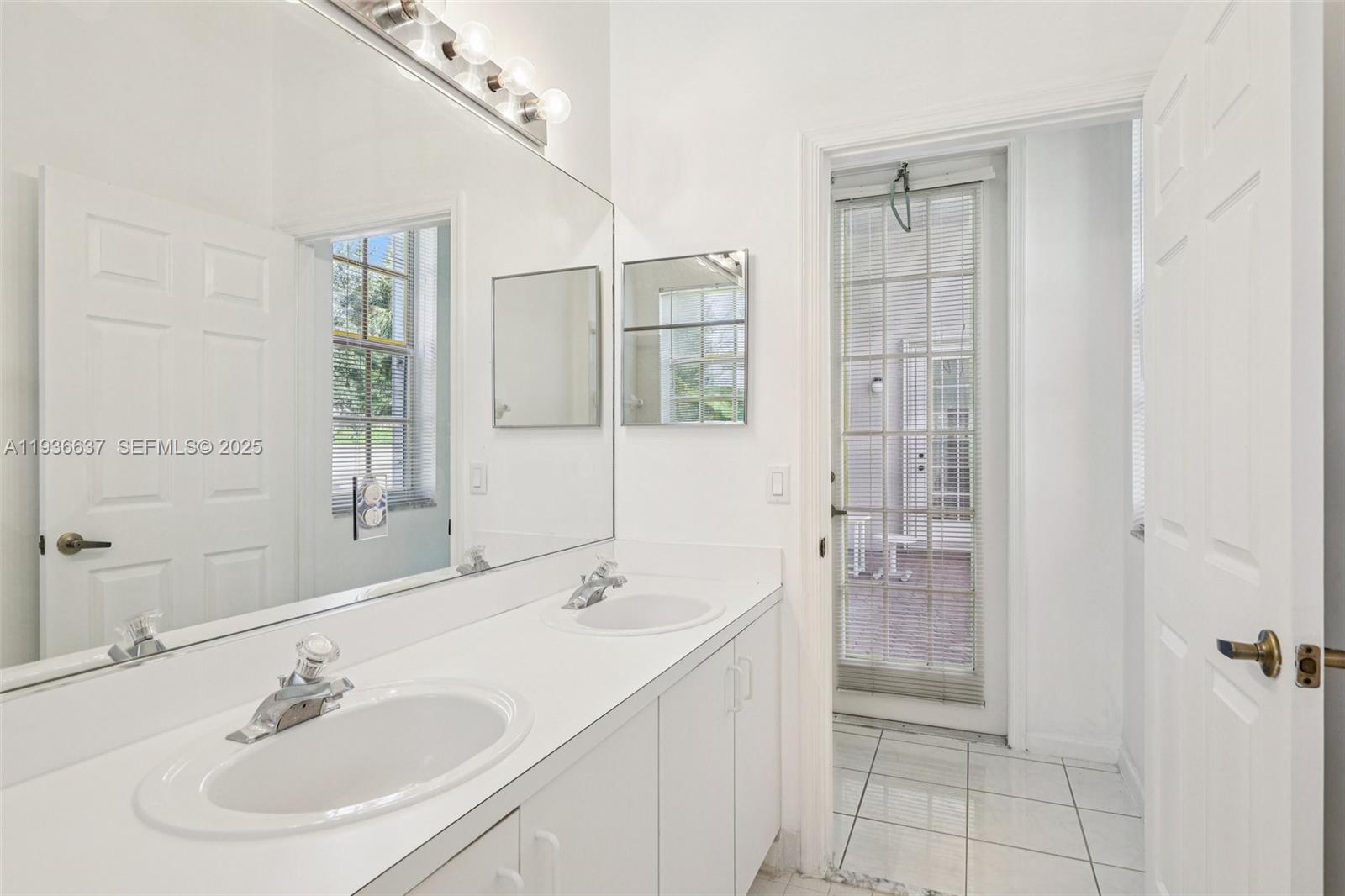 17811 Southwest 4th Court Pembroke Pines, FL 33029 - Photo 48 of 74 a bathroom with a sink shower and a mirror