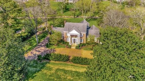 a front view of house with yard and green space