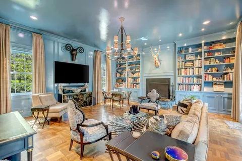 a living room with fireplace furniture and a flat screen tv