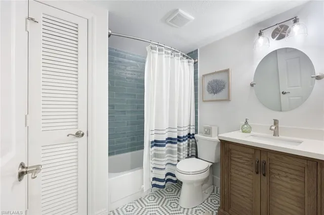 a bathroom with a toilet sink a mirror and shower