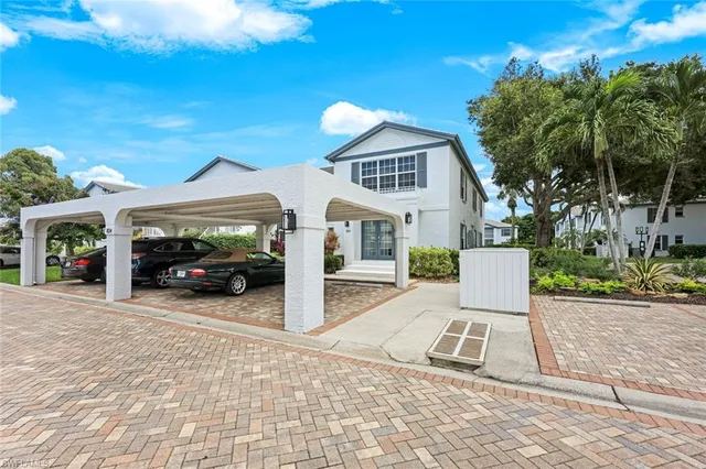 a view of a white house and a yard