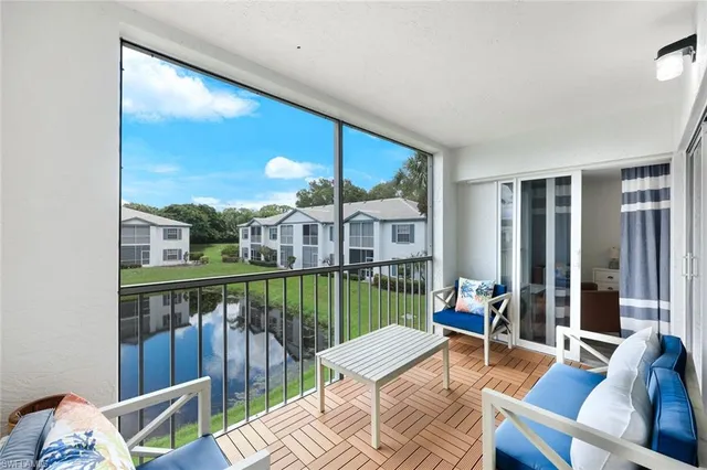a view of a balcony with chairs and a table