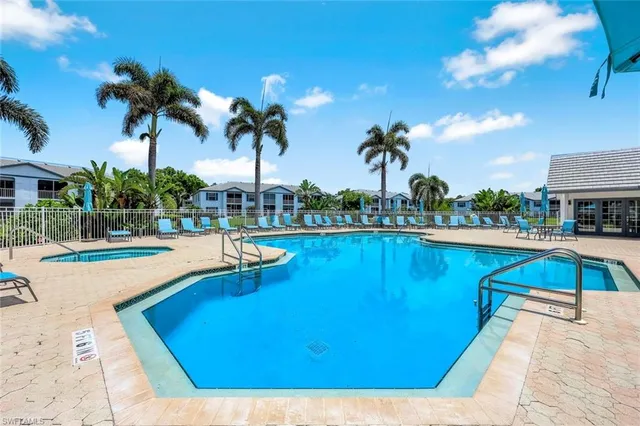 a view of a swimming pool with lounge chair